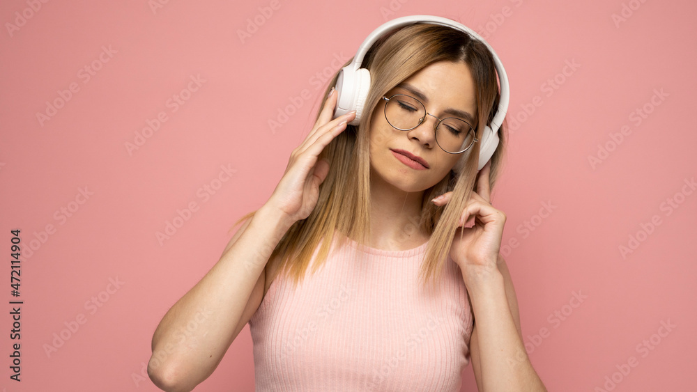 Young beautiful woman in bright outfit enjoying a music. Young beautiful woman in bright outfit enjoying a music.