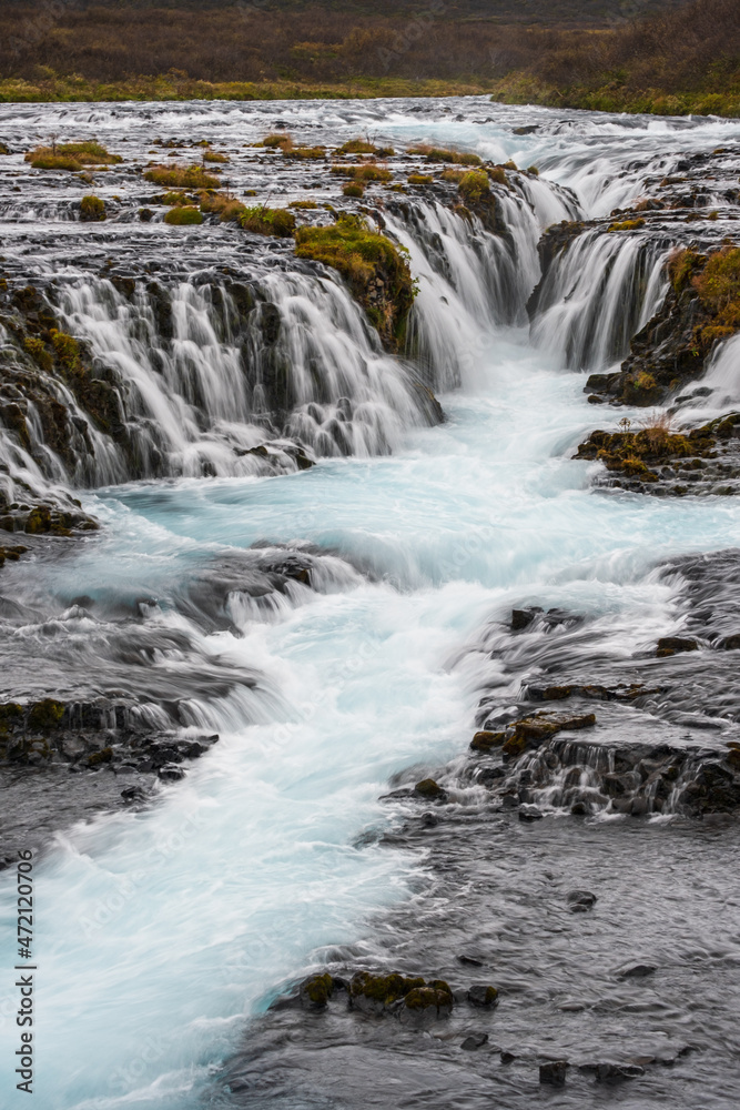 Picturesque waterfall Bruarfoss autumn view. Season changing in southern Highlands of Iceland. Picturesque waterfall Bruarfoss autumn view. Season changing in southern Highlands of Iceland.