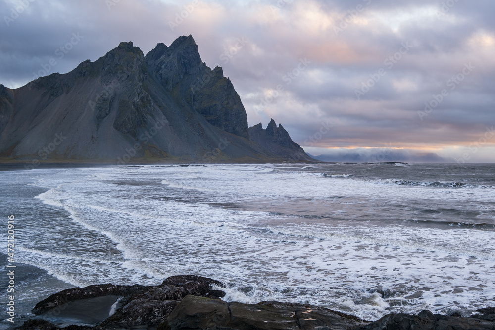 Sunrise Stokksnes cape sea beach and Vestrahorn Mountain with and ocean surf. Amazing nature scenery, popular travel destination.
