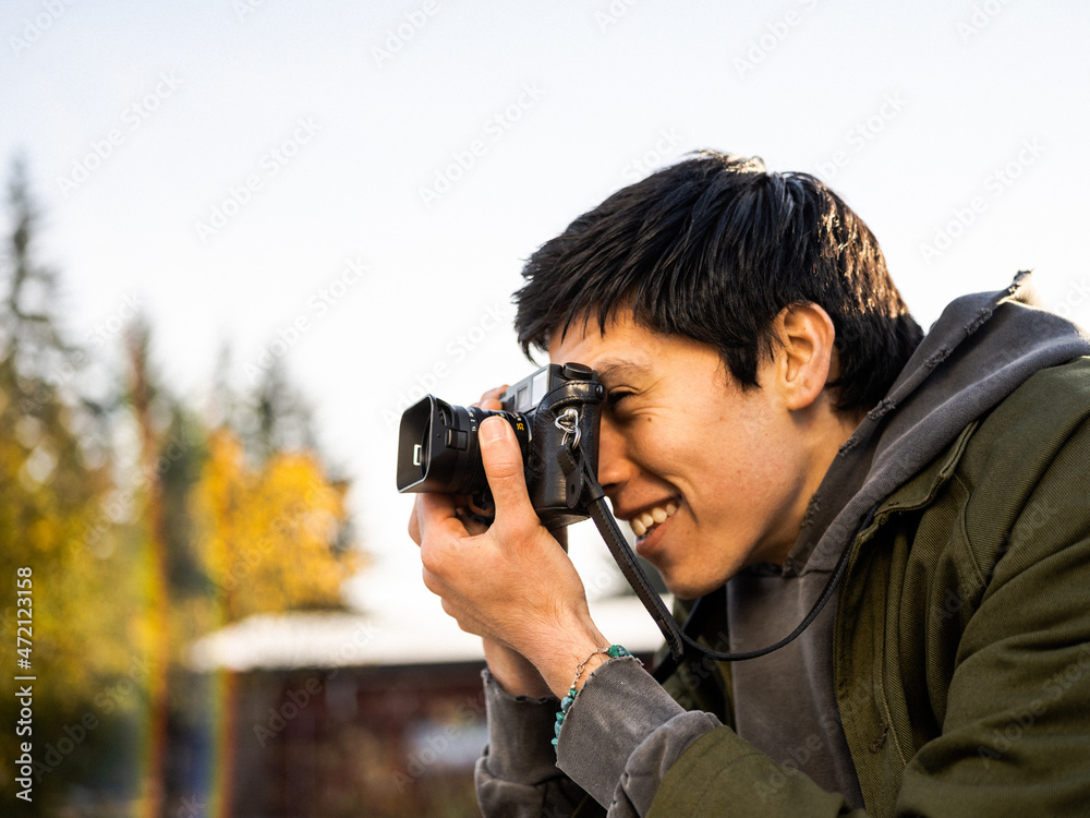 Young Indigenous adult male photographer outdoors Young Indigenous adult male photographer outdoors
