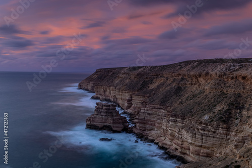 bright sunset sky at island rock after the sun has set at kalbarri national park in western australia