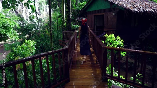 Cute Smiling Asian Girl walking on a bridge by Treehouse Slow Motion, Thailand.