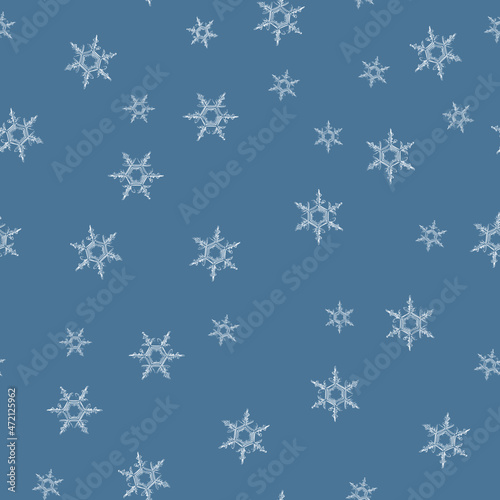 Microscope snowflakes white on light blue seamless pattern