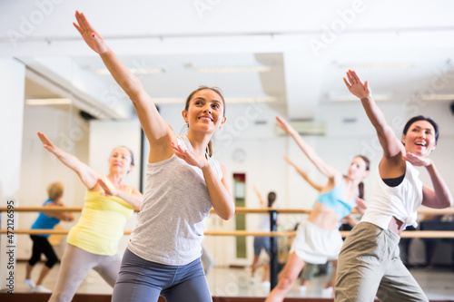 Modern positive active females dancing excited posing in studio