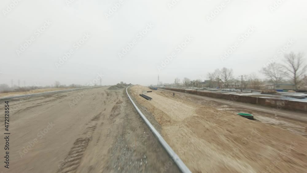 Road construction. Aerial view. Working equipment from tractors, excavators and bulldozers at a construction site. Transport interchange on the outskirts of the metropolis Road construction. Aerial view. Working equipment from tractors, excavators and bulldozers at a construction site. Transport interchange on the outskirts of the metropolis