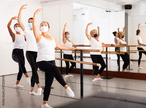 Group of multiethnic dancers training in masks during COVID-19 pandemic
