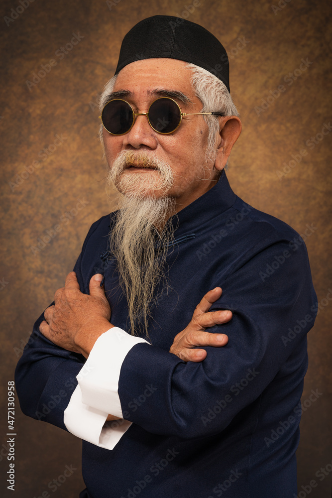 chinese muslim old man wearing sunglasses and kapiah hat with white hair and beard chinese muslim old man wearing sunglasses and kapiah hat with white hair and beard