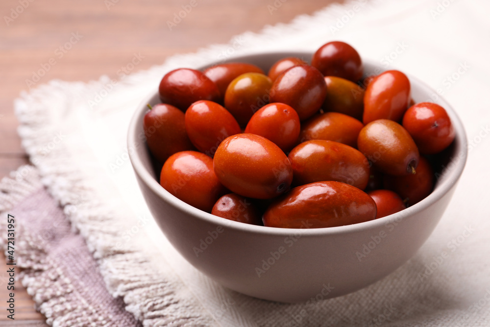 Fresh Ziziphus jujuba fruits in bowl on table, closeup Fresh Ziziphus jujuba fruits in bowl on table, closeup