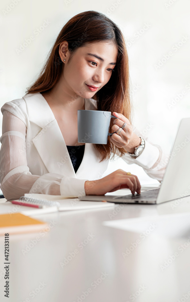 Portrait of asian woman holding mug working at office. Portrait of asian woman holding mug working at office.