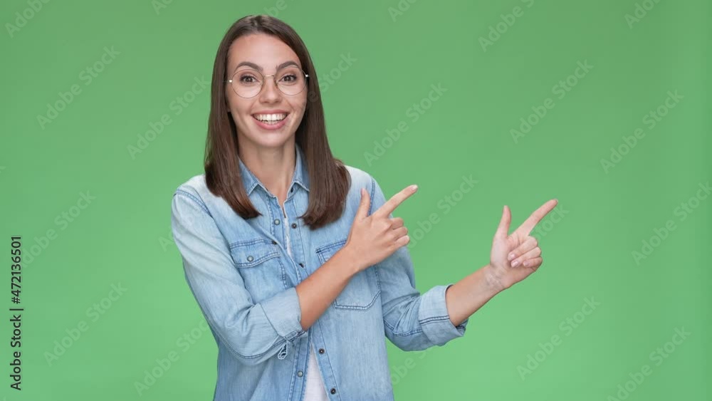 Lady promoter point finger empty space advert isolated green color background Lady promoter point finger empty space advert isolated green color background