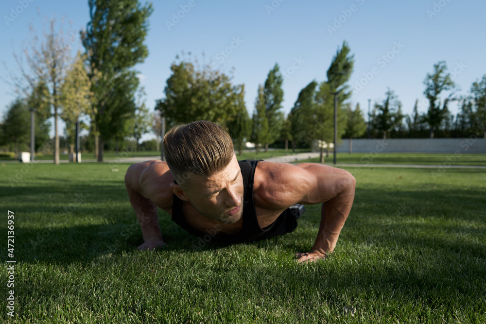 athletic man pumped up body in the park workout fitness fresh air athletic man pumped up body in the park workout fitness fresh air