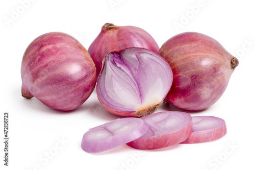 Purple onion or shallot with cut slices on white background.