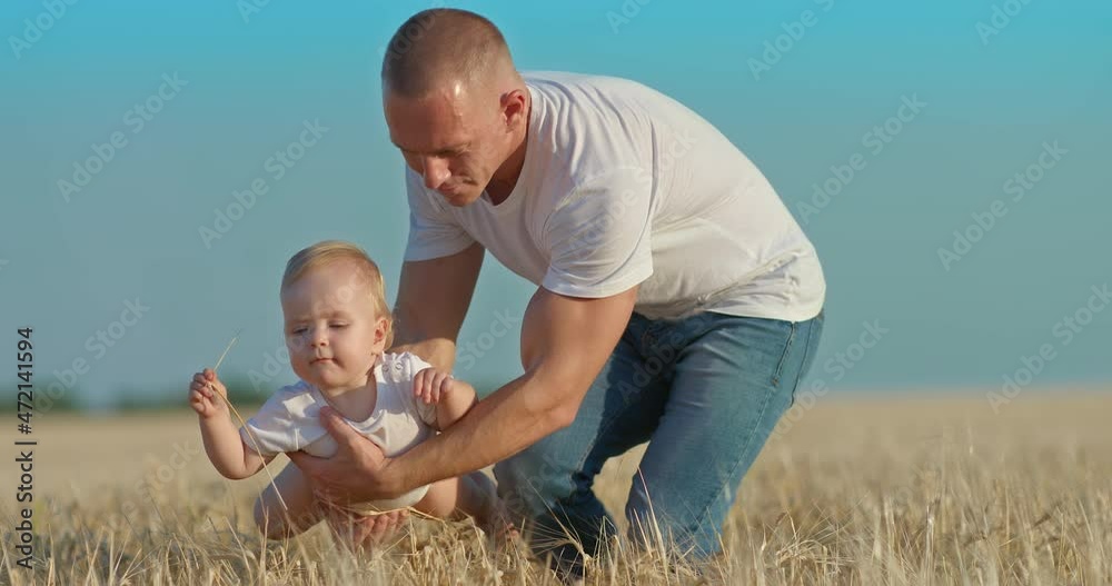 Dad holds the baby in his arms and circles her over the ears of wheat in the field. Loving dad plays with his baby daughter, a walk in the field. Happy fatherhood and childhood. 4k, ProRes Dad holds the baby in his arms and circles her over the ears of wheat in the field. Loving dad plays with his baby daughter, a walk in the field. Happy fatherhood and childhood. 4k, ProRes