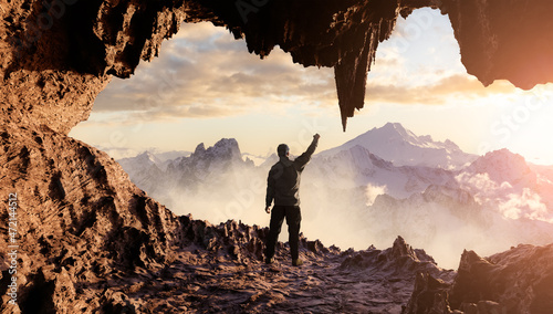 Dramatic Adventurous Scene with Man standing inside an Alien like Rocky Cave Landcspae. 3d Rendering. Sunset Sky. Aerial Mountain Image from British Columbia, Canada. Adventure Concept photo