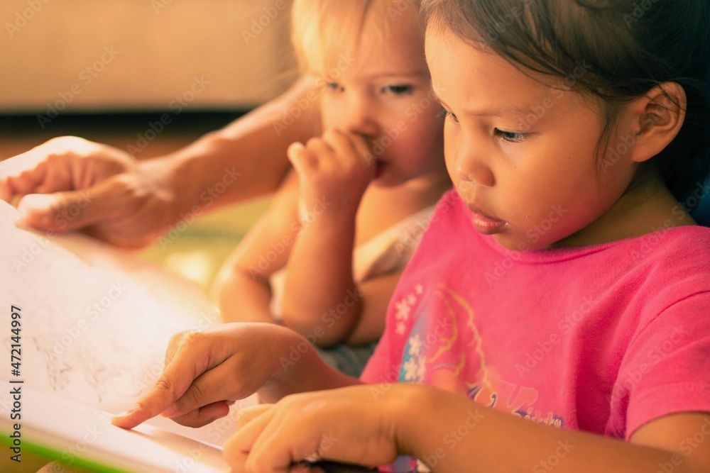 Kids reading books at home. Children learning how to read. Kids reading books at home. Children learning how to read.