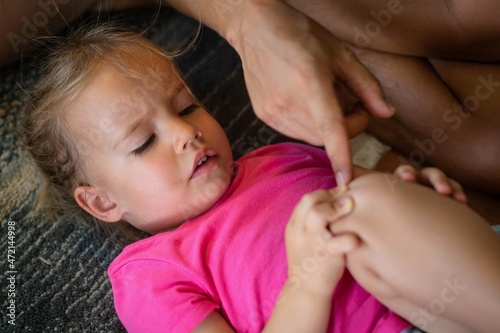 Slika na platnu A little girl with a hurt knee and father teaching and comforting her