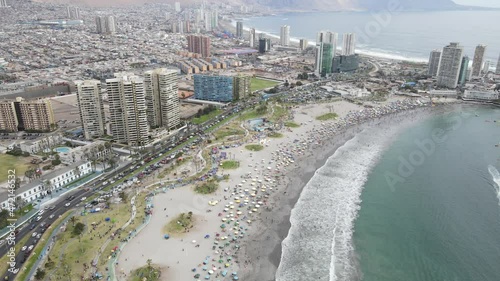 Aerial view of Iquique, Chile, waterfront and beach on Pacific Ocean at afternoon. coastal buildings, traffic and people, drone shot photo