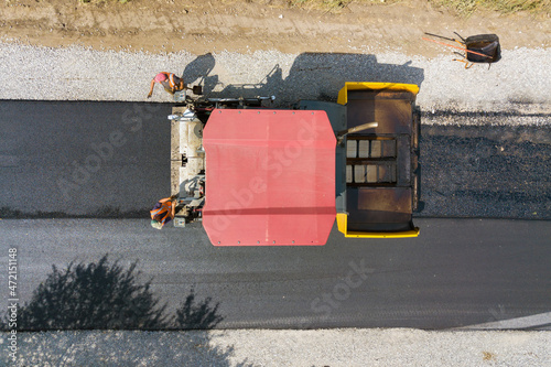 Aerial view of new road construction with asphalt laying machinery at work © bilanol