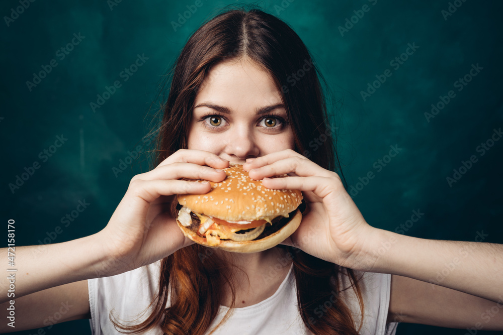 cheerful woman eating hamburger snack close-up lifestyle cheerful woman eating hamburger snack close-up lifestyle