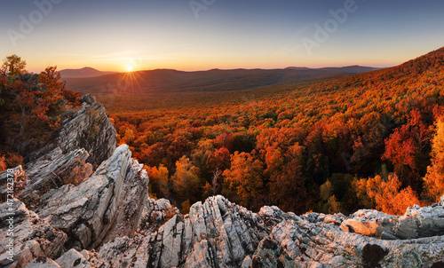 Colorful autumn landscape in the mountains with red forest, Sunset