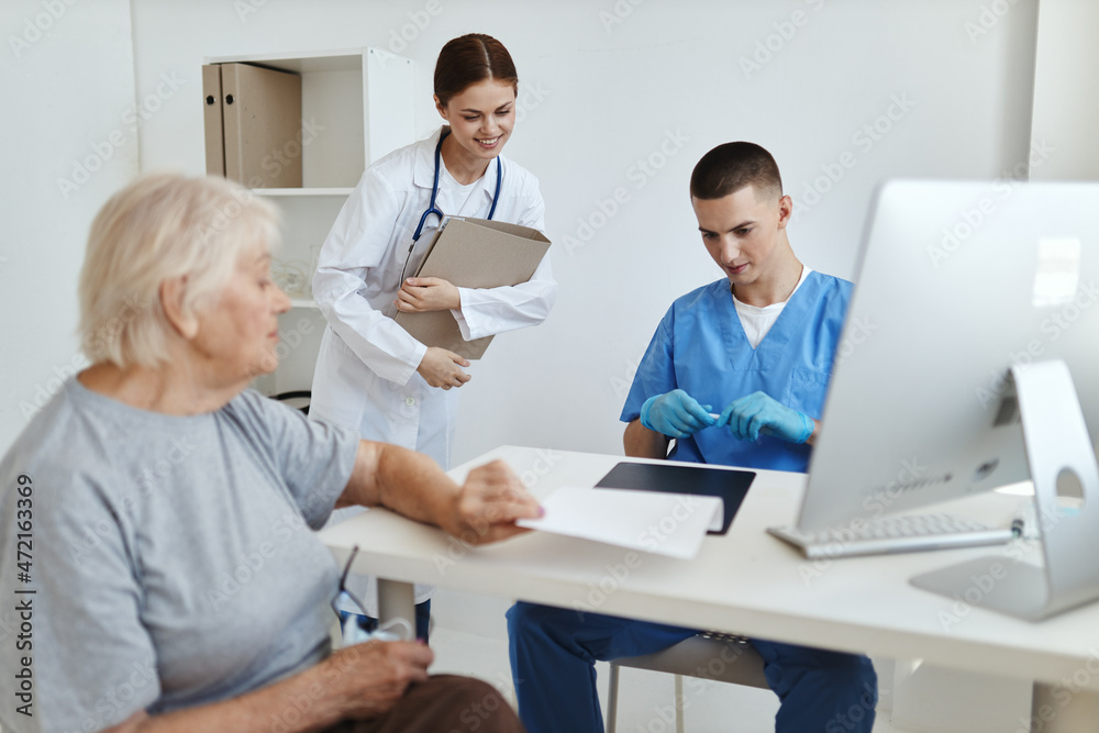 elderly woman at the hospital reception doctor and nurse treatment elderly woman at the hospital reception doctor and nurse treatment