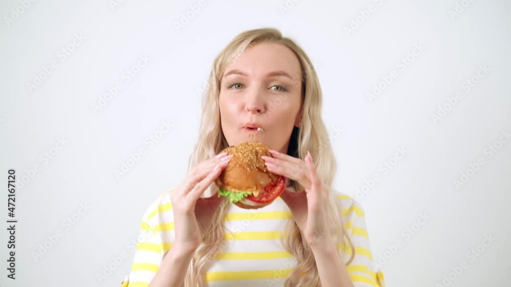Closeup Of Woman Mouth Eating Vegan Burger Closeup Of Woman Mouth Eating Vegan Burger