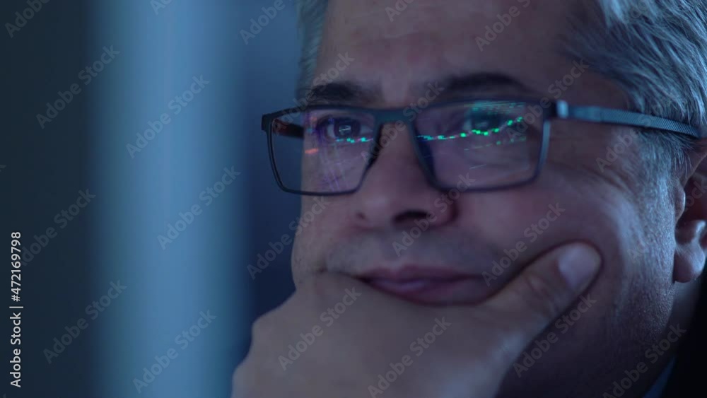 Man following the stock market. Graphics reflected in the glasses of the man who watches the stock market on the computer. Careful follow and green, red graphics. Man following the stock market. Graphics reflected in the glasses of the man who watches the stock market on the computer. Careful follow and green, red graphics.