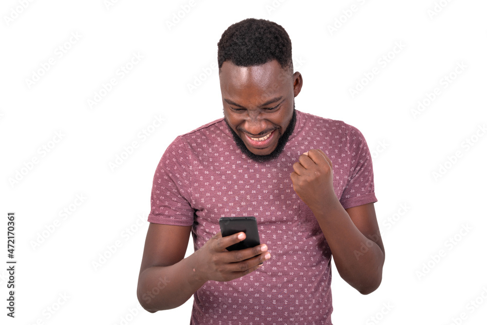 young man using a mobile phone making a winner gesture. young man using a mobile phone making a winner gesture.