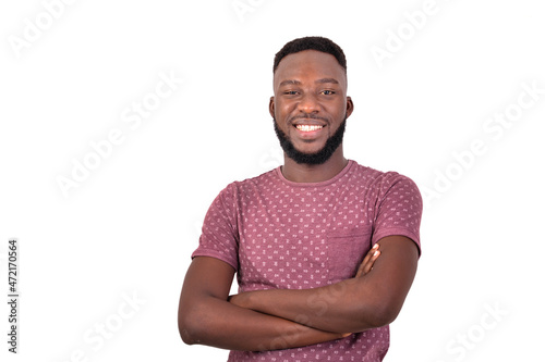 handsome young man crossing his arms smiling.