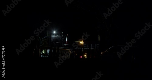 Truck Parked On The Road Under Development With Lights Blinking In The Dark Night. static photo