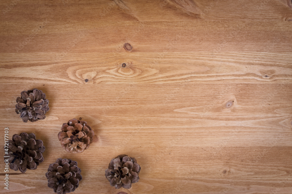 wooden background with pine cones, autumn