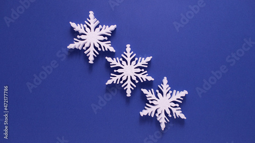 Christmas background with paper snowflake with soft shadows on light blue background