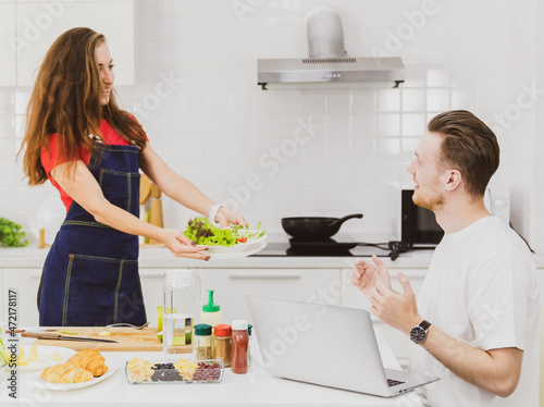 Girlfriend showing salad to boyfriend