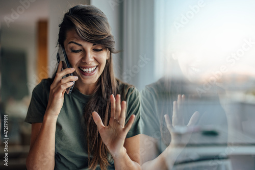 Happy young woman, rejoicing because of the call photo