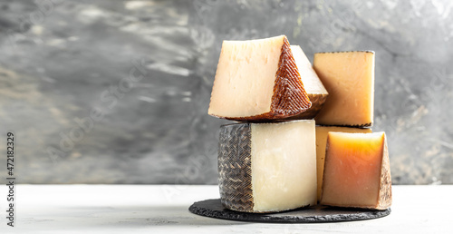 Petit Basque, French cheese, Cheese board of various types of soft and hard cheese. spanish manchego cheese photo