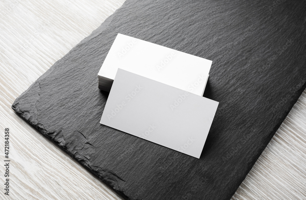 Photo of blank business cards stack on stone board. Template for branding identity. Photo of blank business cards stack on stone board. Template for branding identity.