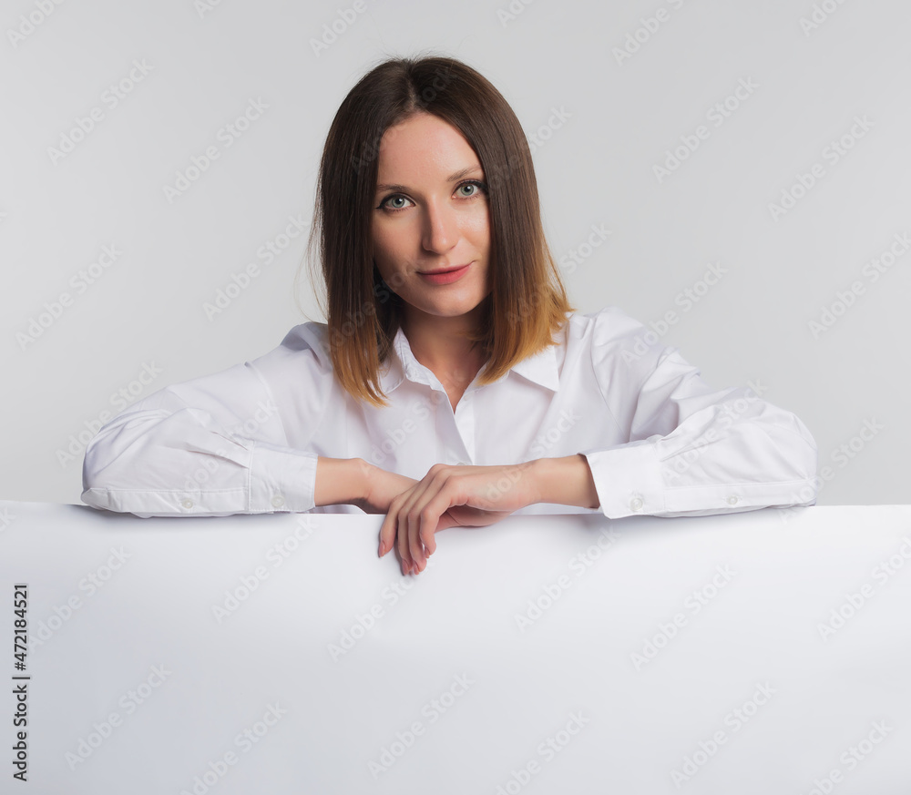 European business woman with blank white banner or blueprints, card isolated studio portrait on grey background, copy space European business woman with blank white banner or blueprints, card isolated studio portrait on grey background, copy space