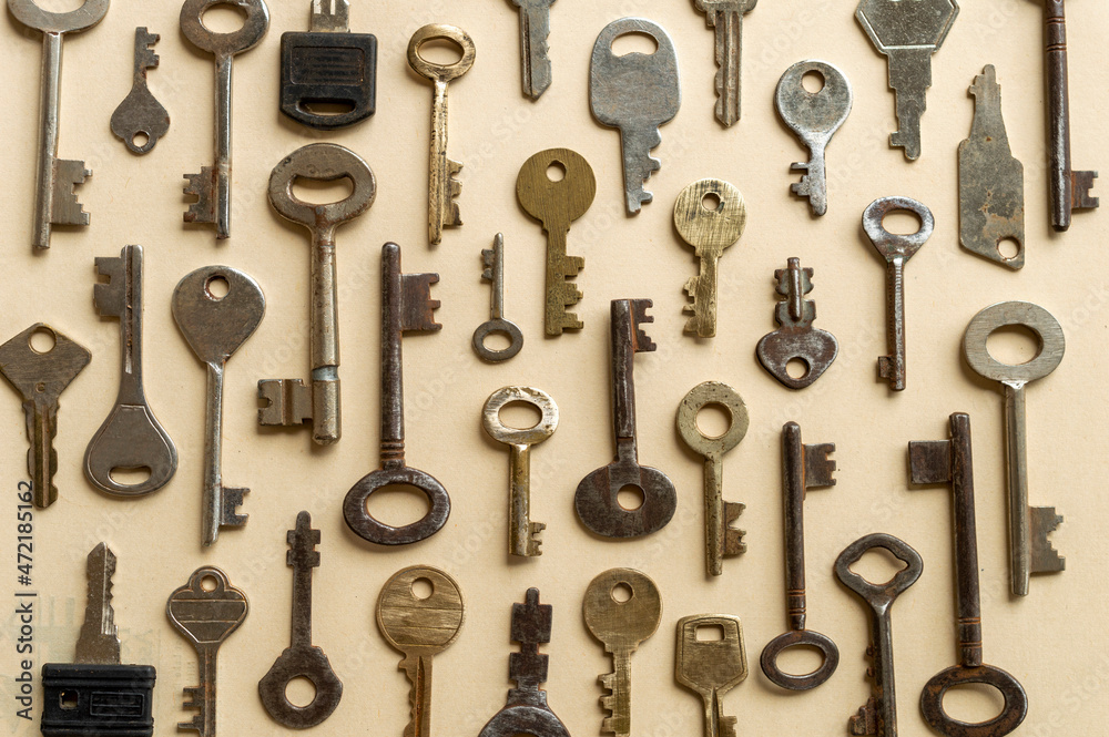 Antique keys are commonly reffered to as a bit or barrel keys, the former having a solid shrank and the latter being hollow. Here are some old antique and vintage keys against paper background. Antique keys are commonly reffered to as a bit or barrel keys, the former having a solid shrank and the latter being hollow. Here are some old antique and vintage keys against paper background.