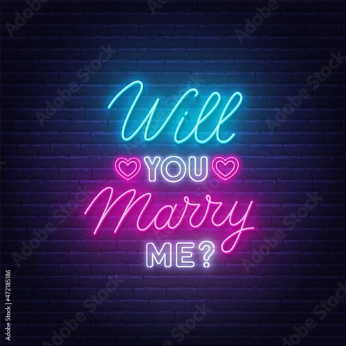 Will You Marry Me neon lettering on brick wall background.