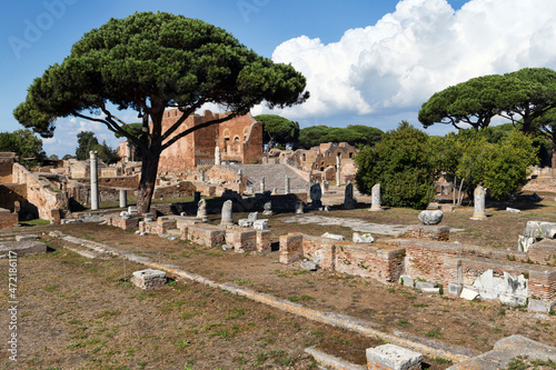 Ancient roman ruins in Rome archaeological excavation of Ostia Antica with Capitolium building and its marbles stairways among the remains of ancient Roman buildings, columns and statues