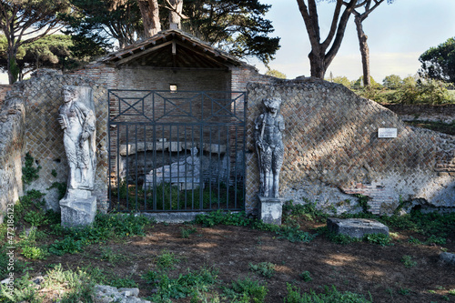 The Shrine of Attis or Attideum with its graven statues surrounded by ancient ruins, a beautiful cultural travel in the Roman age at archeological excavations of Ostia Antica in Rome, Italy