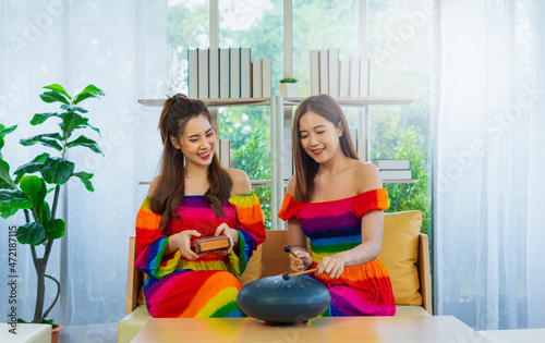 young couple women play musical instrument, tongue drum and kalimba