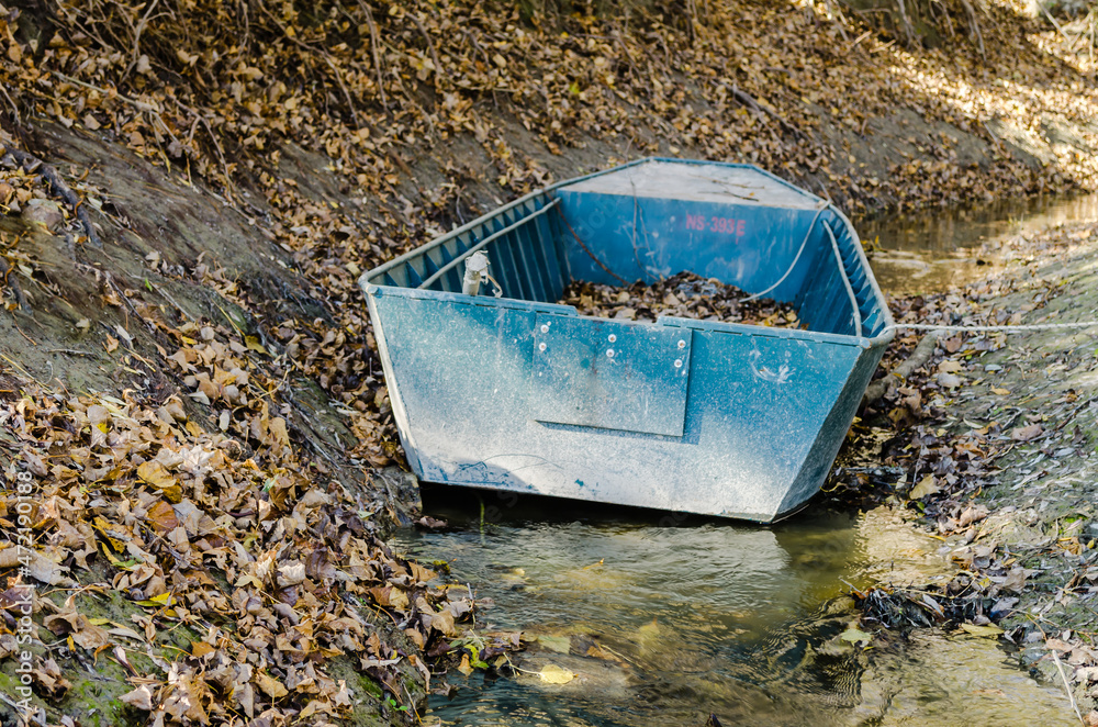 The banks of the Danube River in Begec. A fishing boat on a stream that flows into the Danube River near the city of Novi Sad. The banks of the Danube River in Begec. A fishing boat on a stream that flows into the Danube River near the city of Novi Sad.