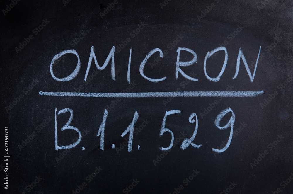 Obraz premium New variant of the Covid-19 Omicron B.1.1.529 medical banner, mixed media. New strain of coronavirus. Black school board and chalk text.