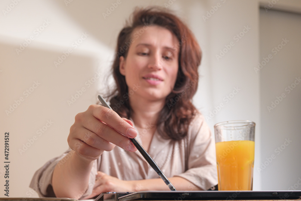 An artist paints a picture with a brush and watercolors