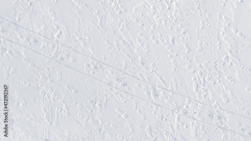 footprints and sledge marks on the snow viewed from drone above