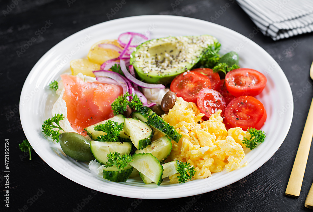 Salt salmon salad with tomatoes, cucumbers, scrambled eggs and avocado. Ketogenic diet breakfast. Keto lunch.