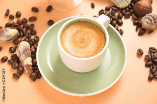 Coffee chocolate. Espresso with froth or macchiato in small cups, sprinkled coffee beans and chocolates. view from above. High quality photo. Copy space