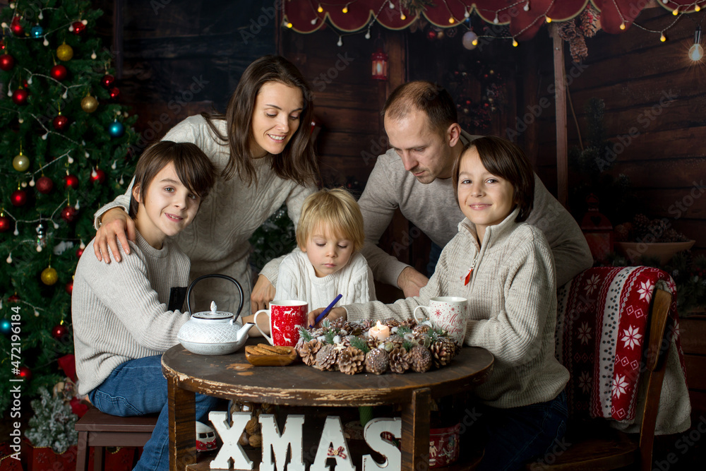 Happy family with children and pet dog, enjoying Christmas time together, celebrating Happy family with children and pet dog, enjoying Christmas time together, celebrating
