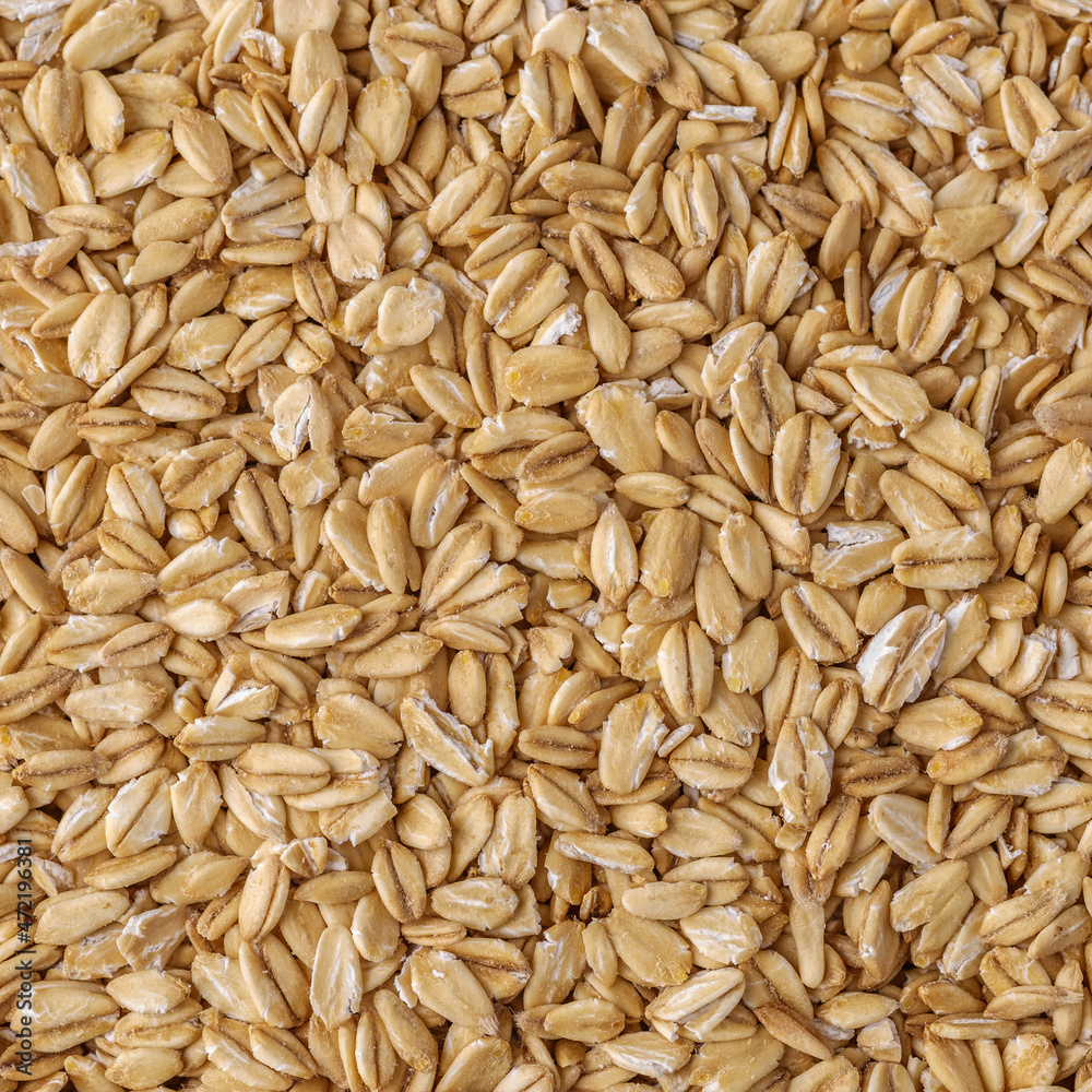 Rolled oat, oat flakes background or texture. Close up, directly above.Heap of dry rolled oats isolated. Rolled oat, oat flakes background or texture. Close up, directly above.Heap of dry rolled oats isolated.
